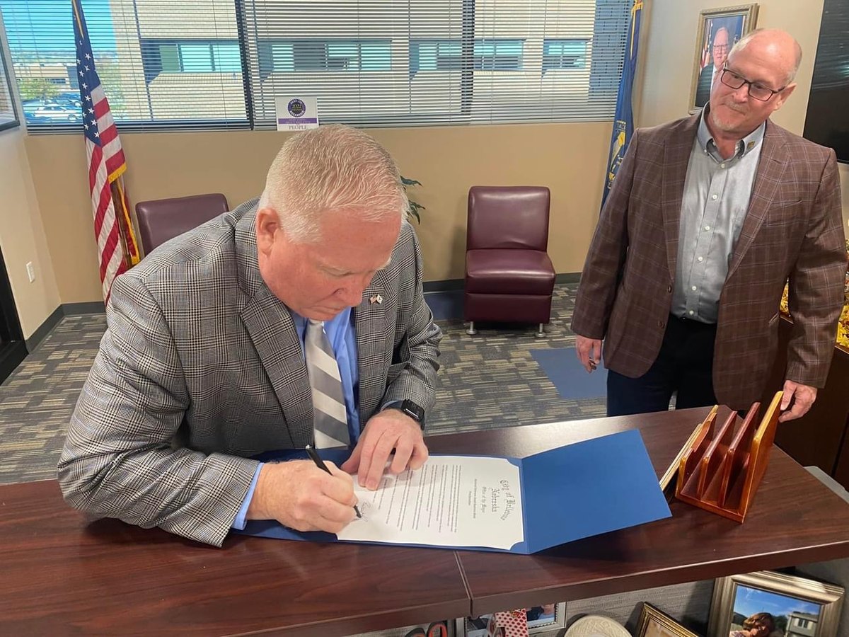 Mayor Rusty Hike signing a City of Bellevue proclamation